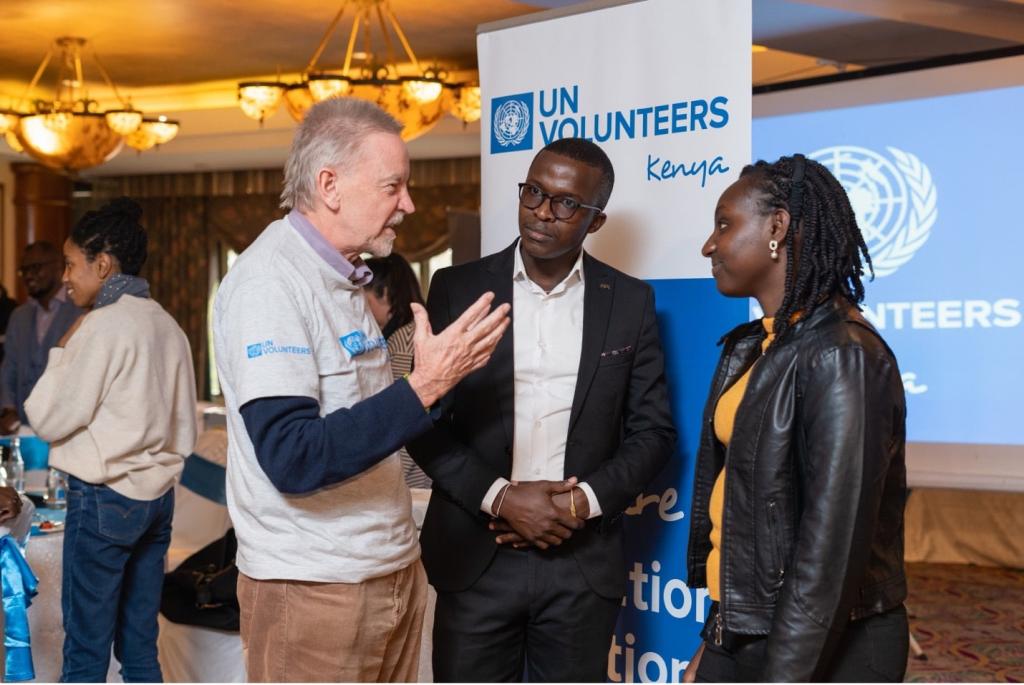 Charlie Bartlett (left) and Caroline Kamau (right) interacting after their conversation on intergenerational solidarity for climate action at the UNV Kenya CDLF2022 training event. Listening in (centre) is one of the training facilitators.