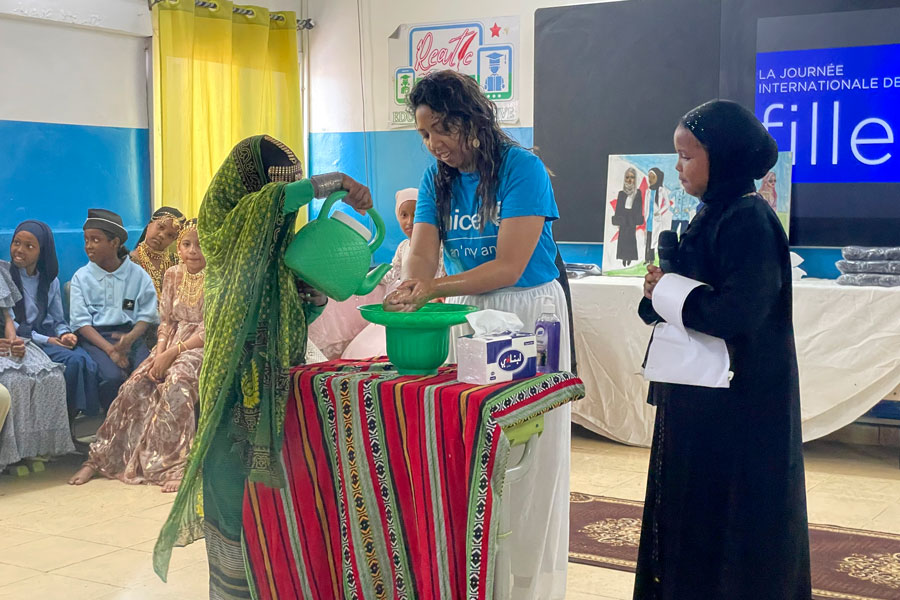 UNICEF staff teaches proper handwashing techniques to children in class.