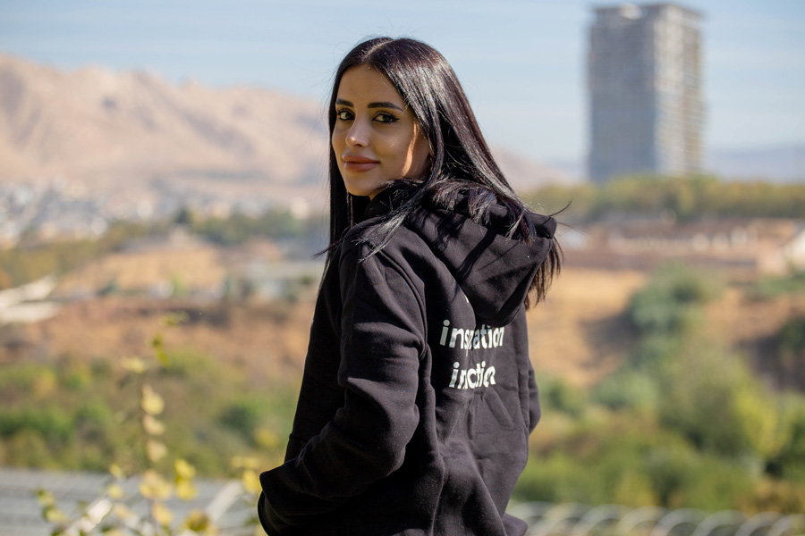 Young woman outdoors wearing a black hoodie