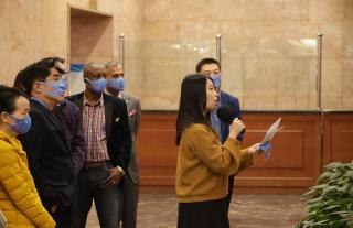 Weng Huiling (in front, holding a microphone) guides the exhibition tour on Zero Discrimination Day