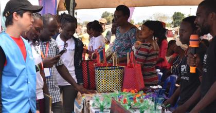 Shuhei Nishiyama (left) UN Volunteer Associate Protection Officer with UNHCR at Nakivale refugee settlement supported young people in activities on Youth Talent Day.