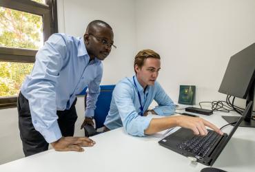 UN Volunteers Kyle Jacque (right) and Godfrey Mukalazi (left) consulting on activities for the “Support the Sudanese Peace Process” project.