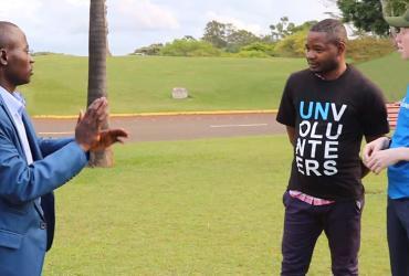 Moses Chubili (left), national UN Volunteer Coordination and Partnership Officer in Zambia, converses in sign language with Gift Govere, national UN Volunteer Project Officer in Zimbabwe (far right) during Assignment Preparation Training in Kenya.