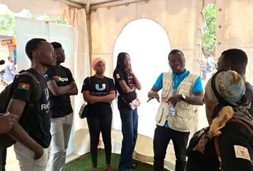 Wendpanga Nicolas Djiguemde, UN Volunteer Project Officer with UNICEF interacts with young people at a cultural activity in Bobo Dioulasso.