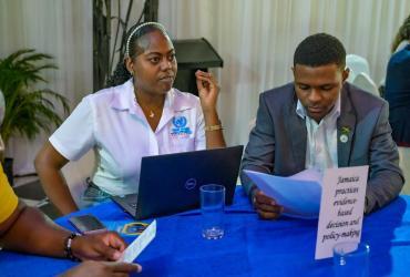 Priyanka Mais (left) UN Volunteer at an event centered on evidence-based decision and policy making in Jamaica.