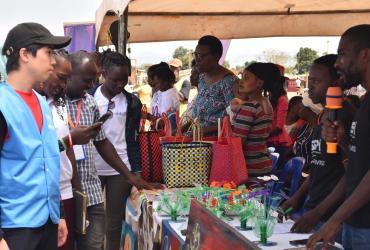 Shuhei Nishiyama (left) UN Volunteer Associate Protection Officer with UNHCR at Nakivale refugee settlement supported young people in activities on Youth Talent Day.