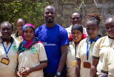 UN Volunteer Blasio Amoche Omulama, Monitoring and Evaluation Specialist (WFP) with the ‘Rescue Divas Women’s VSLA Group’ in Isiolo County, Kenya.