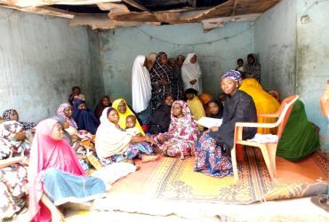UNV Community Village Supervisor Falmata Haruna Bwala (right) promotes the inclusion of women in the VSLA program within the Mafoni community, Maiduguri, Borno State. @UNV 2018