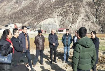 UN Volunteer Zeng Yunheng (China) during a field visit to local farms with agricultural experts in Zhouqu in January 2020