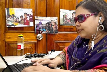 Nazma Ara Begum Poppy works at her desk at the UN Women Bangladesh office in Dhaka