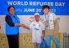 Denny Beryan Saputra, international UN Volunteer Specialist Associate Operational Data Management Officer (right) during a UNHCR organized art contest on World Refugee Day on 20 June 2023. The children showcased their creativity through the power of art to connect, empower, and inspire. 