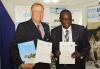 UNV Executive Coordinator Richard Dictus (left) and Ambassador Dr. Kipyego Cheluget, ASG of the Common Market for Eastern and Southern Africa (COMESA) (right) sign a MOU to establish the COMESA Youth Volunteer Scheme.