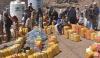Families line up for water distribution in Yemen.