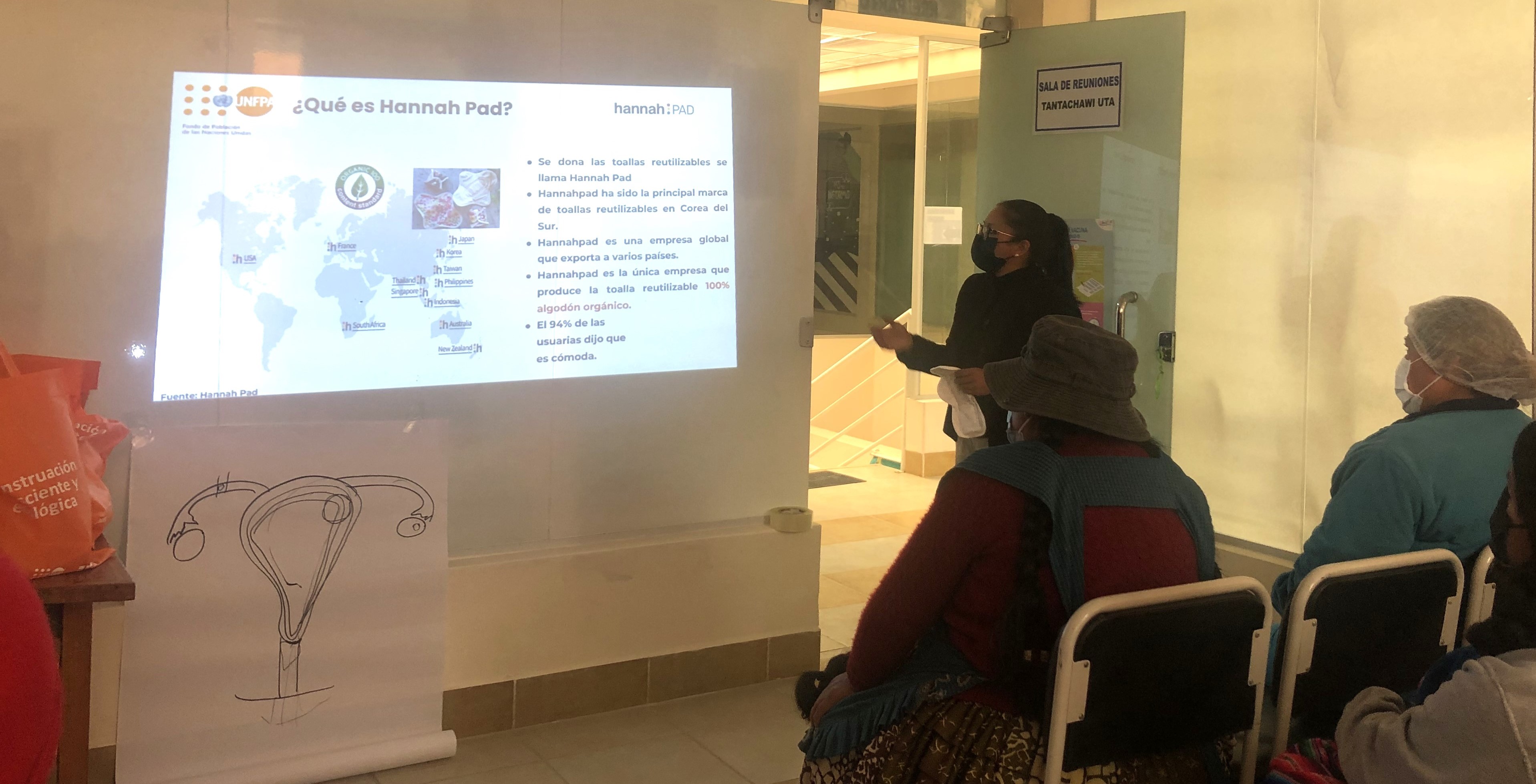 Mayra Adriana Lopez Diaz (right), a UN Volunteer Local Monitor for Reproductive and Sexual Right serving with UNFPA in Bolivia, presents on menstrual health and hygiene among adolescent girls and women in La Paz.