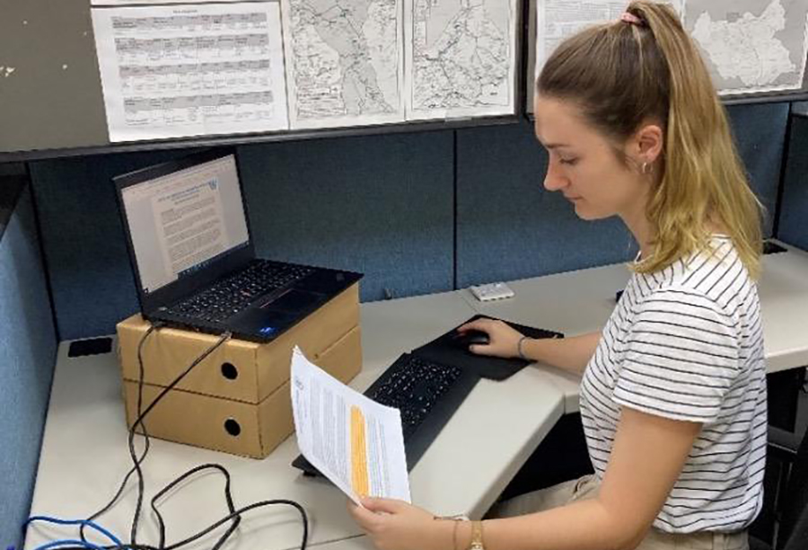 UN Volunteer Abigail Skotnes (South Africa) prepares analytical reports at her desk in UNMISS Headquarters, Juba, South Sudan. 