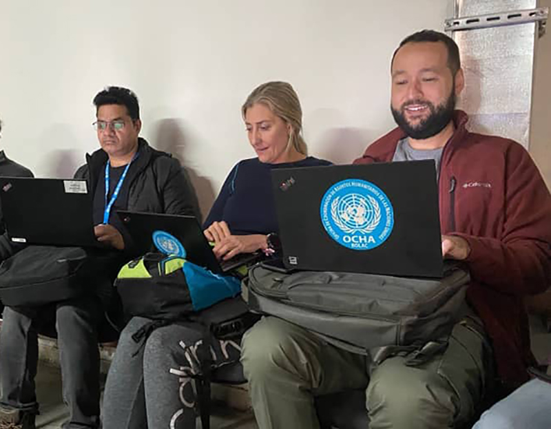 UN Volunteer Anthony Prassoulis (right), with OCHA colleagues Brenda Eriksen (centre) and Vijay Singh (left), working out of a bunker at the Ramada Hotel in Kyiv. ©Amanda Pitt/OCHA, 2022